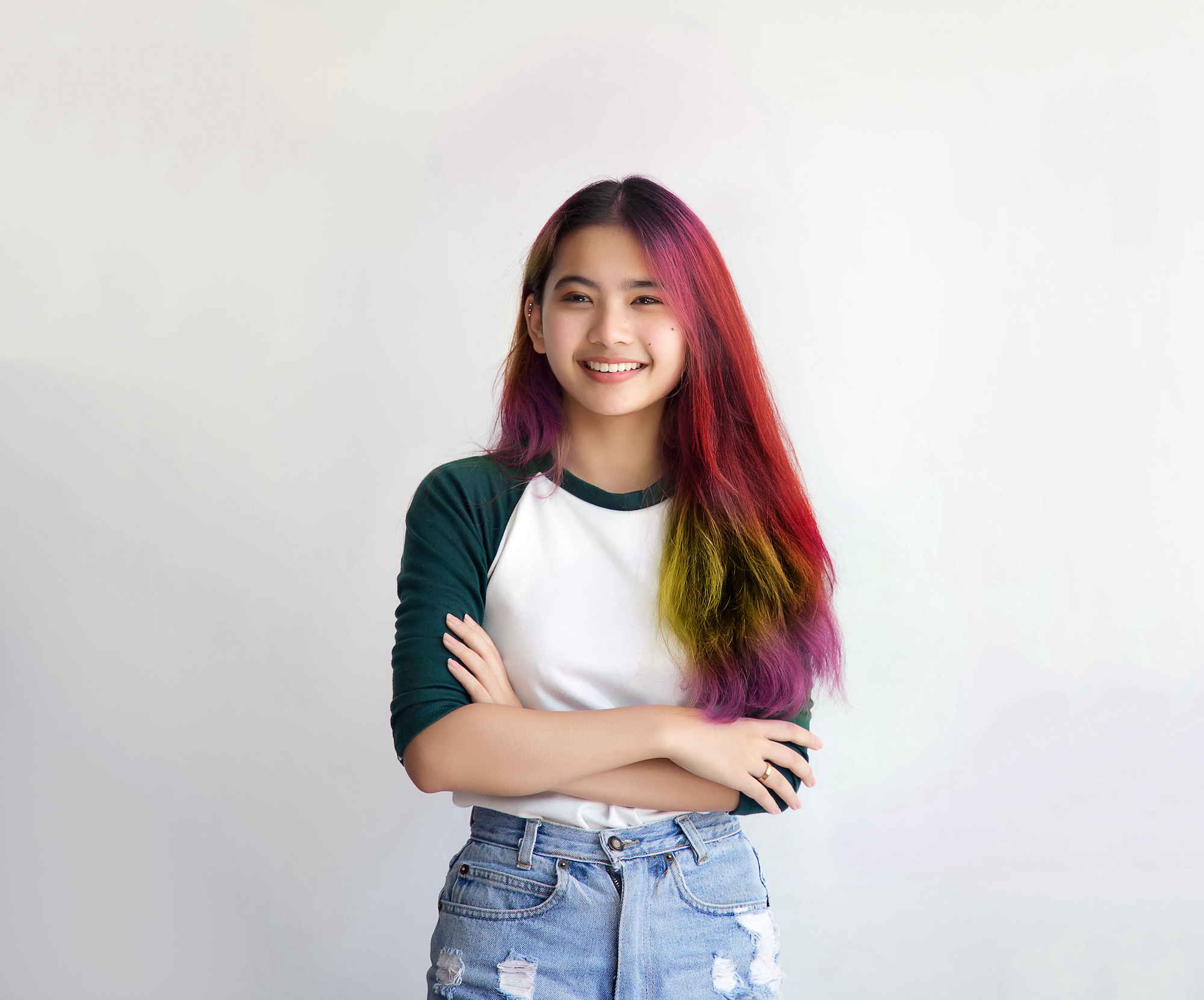 pretty asian femele smiling joyfully with colorful hair in dressed casually like hipster lifestyle, Independent fashion concept.